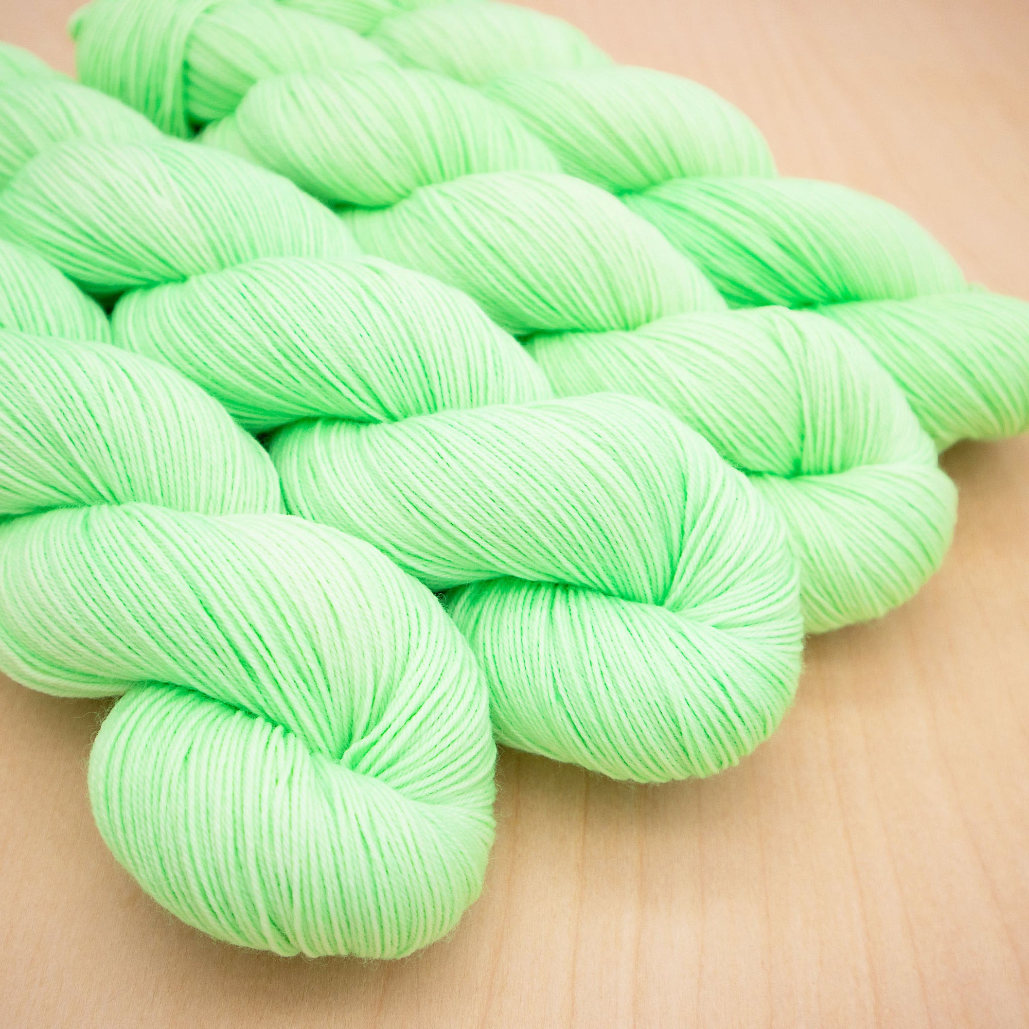 A skein of bright mint green yarn.